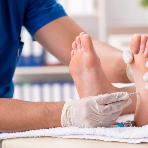 Podiatrist treating feet during procedure